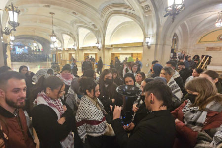 Chicagoans gather inside City Hall to await the vote on the ceasefire resolution