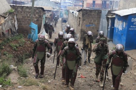 Kenyan anti-riot police patrol a slum during anti-government protests in 2023.
