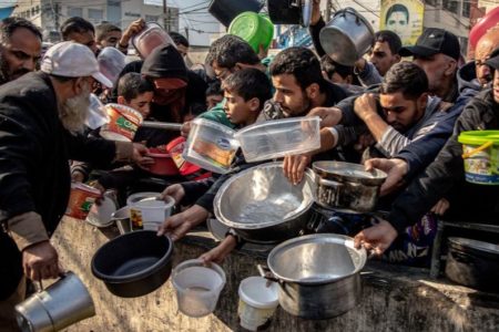 Displaced Palestinians wait for food at Al-Shaboura camp, in Rafah. Photo: WHO via UN Photo