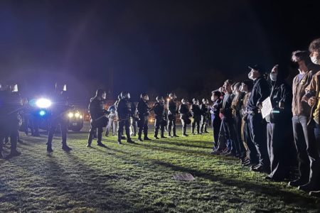 Cops in riot gear encircling the Dartmouth encampment in New Hampshire. Photo: PSL