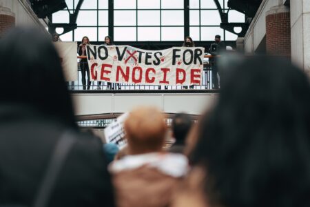 Protesters hang a banner reading "No votes for genocide" ahead of the US presidential elections in Boston, MA. The Israeli genocide in Gaza has become one of the defining issues of the elections. Photo: Micah Fong/PSL