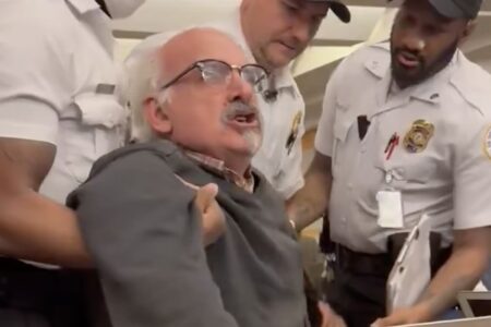 Journalist Sam Husseini is dragged out of State Department briefing room.