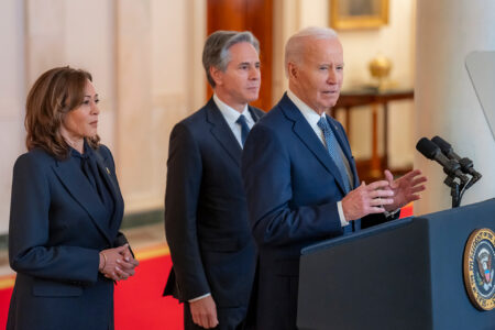 President Biden stands in front of Vice President Harris and Secretary of State Antony Blinken (Photo via @POTUS/X)