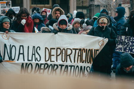 Demonstrators denounce Trump's mass deportation plans at a rally in Boston on January 20 (Photo: Micah Fong)