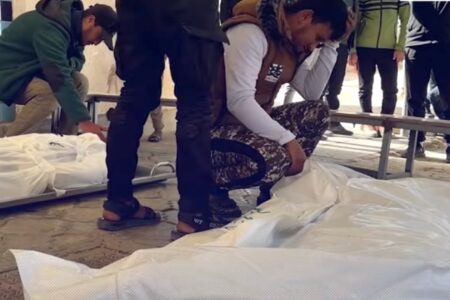 The bodies of the three martyred police officers are prepared for burial.
Photo: Screenshot