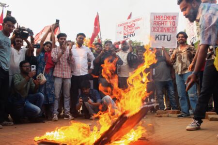 Angry tech workers burn IT tycoon Narayana Murthy’s cardboard portrait scrawled with his call for a "70-hour work week". Photo: KITU