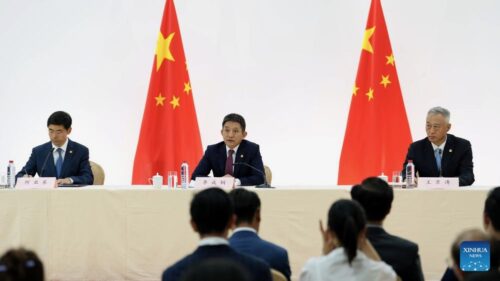 Chinese leaders at press conference in front of Chinese flags