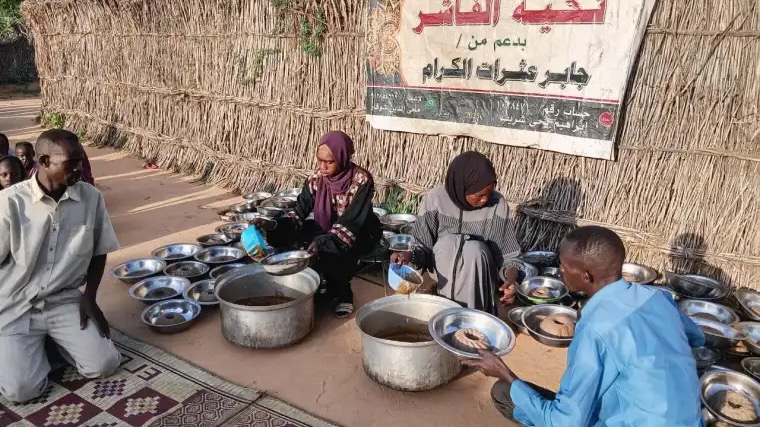 displaced residents receive food at communal kitchen in Sudan