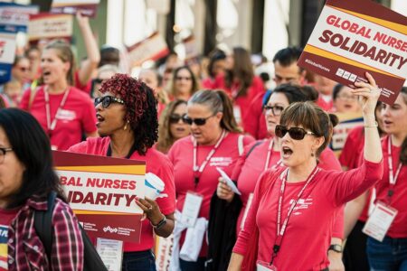 Health worker migration still shaping healthcare after COVID-19 Nurses protest with signs that read: Global Nurses Solidarity