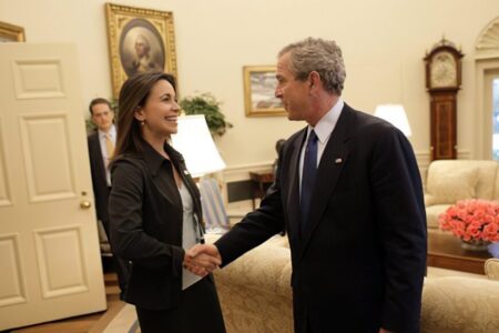 Maria_Corina_Machado_(Sumate)_meets_George_W._Bush_(2002) In 2002, former US President George W. Bush meets María Corina Machado, then director of Súmate, an "independent democratic civil society group" funded by the US government to "oversee the electoral process in Venezuela". Source: White House/Eric Draper
