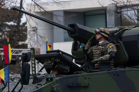Romania Military Parade 2024 A Romanian soldier salutes at the National Day Parade in Bucharest, Romania, Dec. 1, 2024. Source: Wikimedia Commons/ US Army