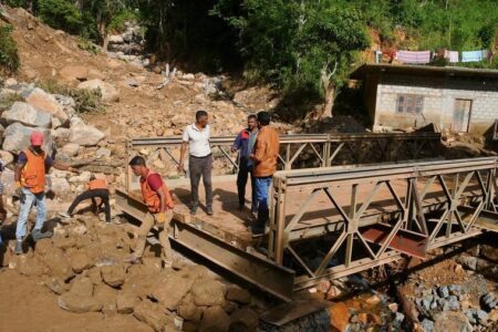Sri Lanka Cyclone Ditwah IMF debt economic crisis (1) People repair a collapsed bridge affected by Cyclone Ditwah in Badulla District, Sri Lanka, Dec. 13, 2025.