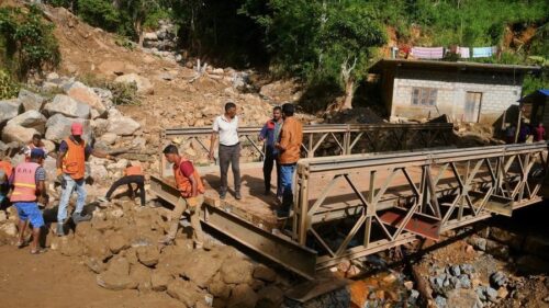 People repair a collapsed bridge affected by Cyclone Ditwah in Badulla District, Sri Lanka, Dec. 13, 2025.