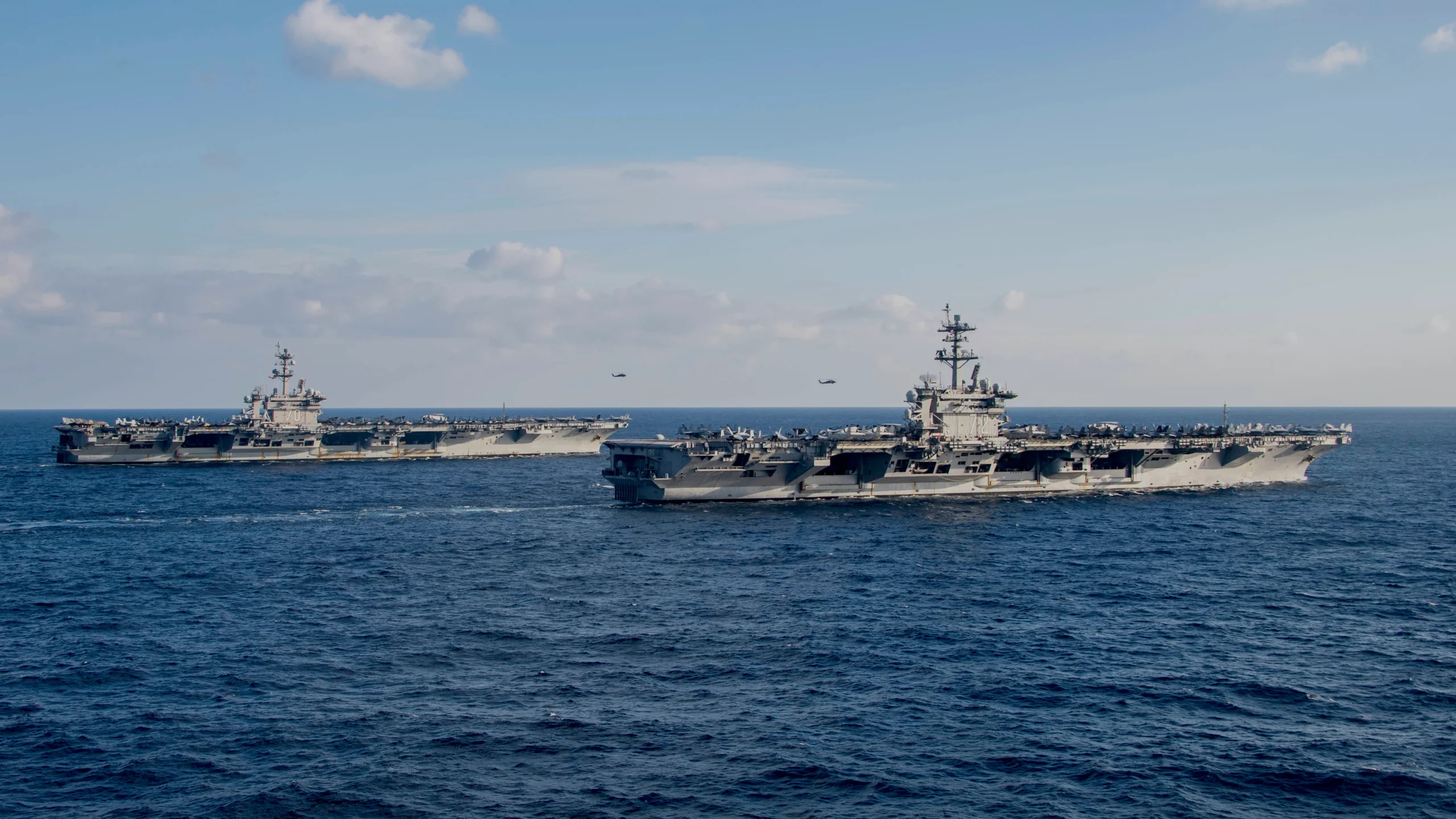 Nimitz-class aircraft carriers USS Carl Vinson (CVN-70), left, and USS Abraham Lincoln (CVN-72) transit the Philippine Sea/South China Sea on Jan. 22, 2022.