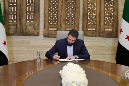 Ahmad Al-Sharaa signs document Ahmad Al-Sharaa signs document