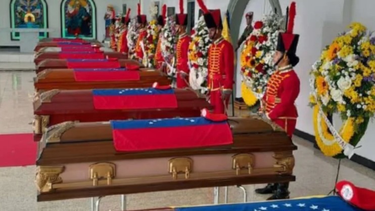 Venezuelan soldiers stand over coffins of those killed in US attack