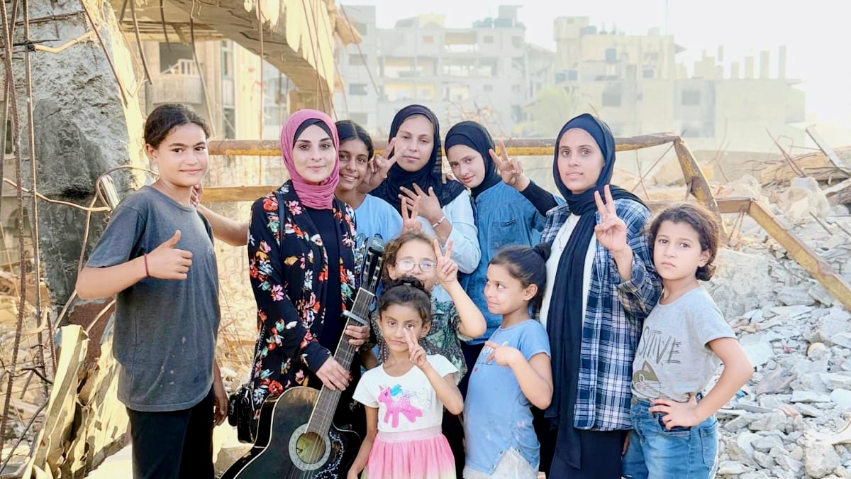 Palestinian music teacher Rola Dalloul with her students in Gaza