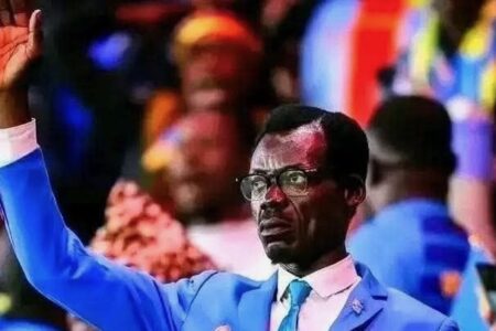 Patrice Lumumba look-alike fan at AFCON (1) Patrice Lumumba look-alike at AFCON stands motionless in the stands