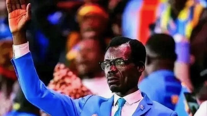 Patrice Lumumba look-alike at AFCON stands motionless in the stands