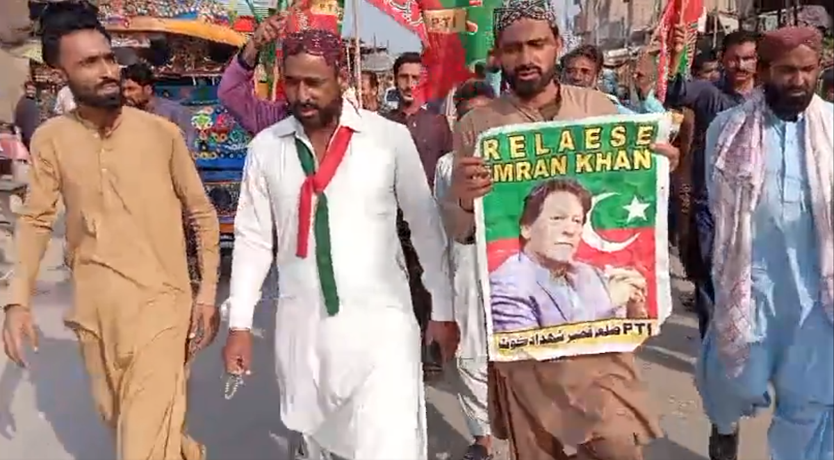 Protesters hold poster of former Prime Minister of Pakistan, Imran Khan, during national strike