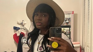 Young woman poses in mirror