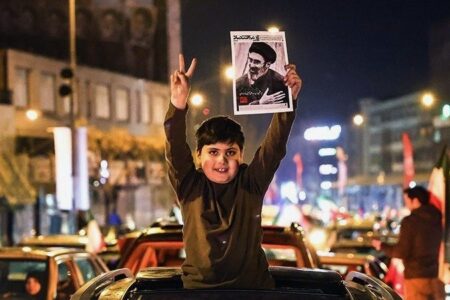 Crowds gather in Tehran March 9 to celebrate the appt of the new supreme leader (1) Boy holds up victory sign and poster of Iranian supreme leader