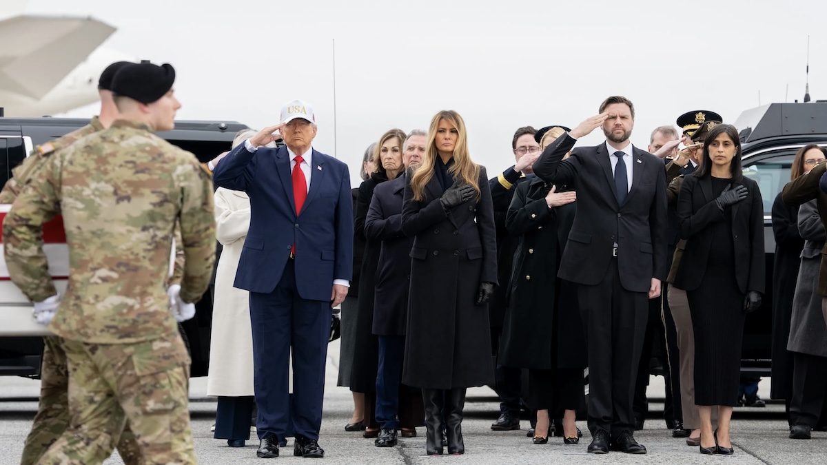 Donald Trump and JD Vance salute as coffins are carried off plane