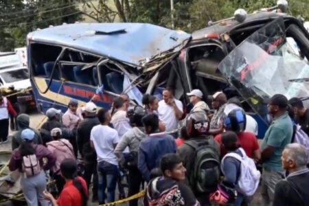 People gather next to an exploded bus on the Pan-American Highway in Colombia People gather next to an exploded bus on the Pan-American Highway in Colombia