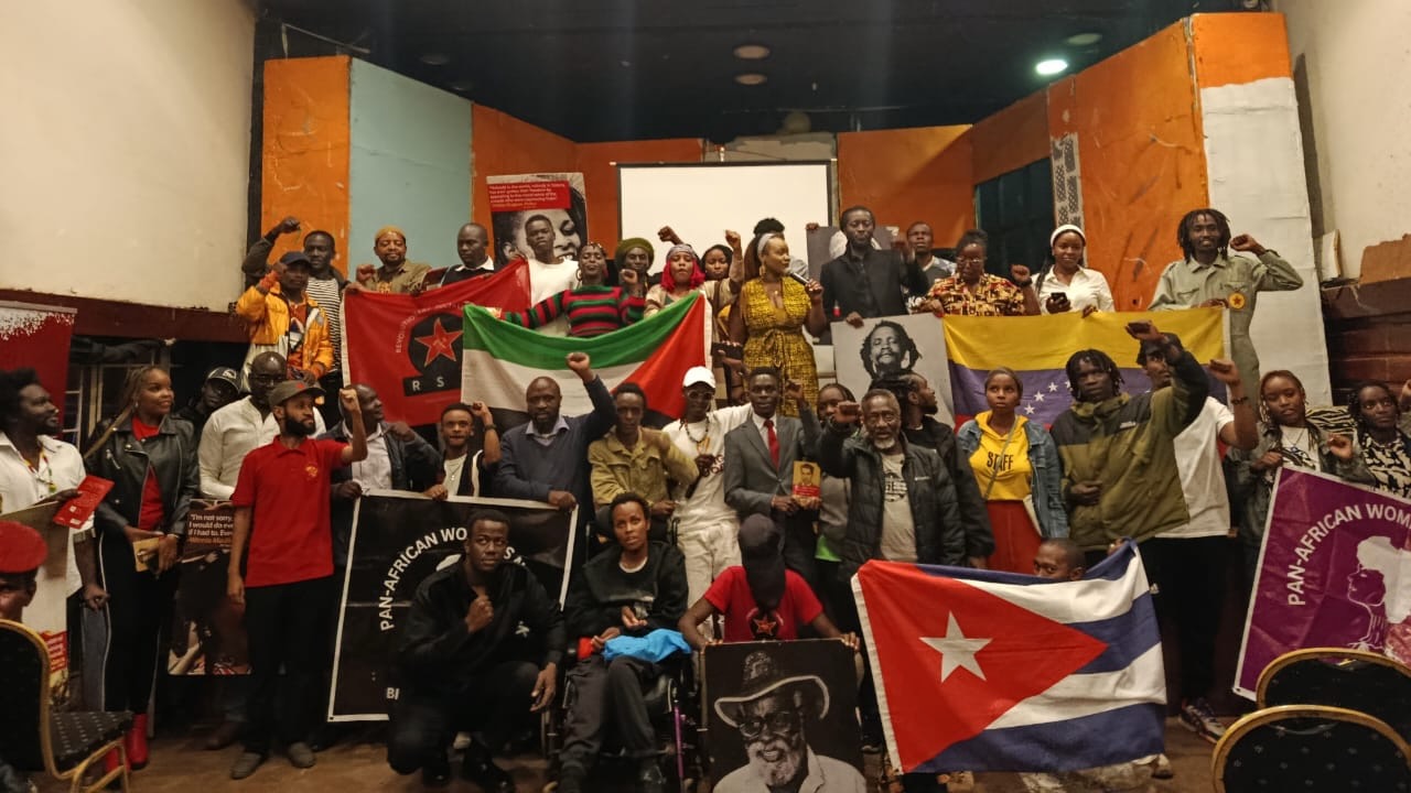 Kenyan socialists and leftists raise international revolutionary flags during a forum for African Liberation Day
