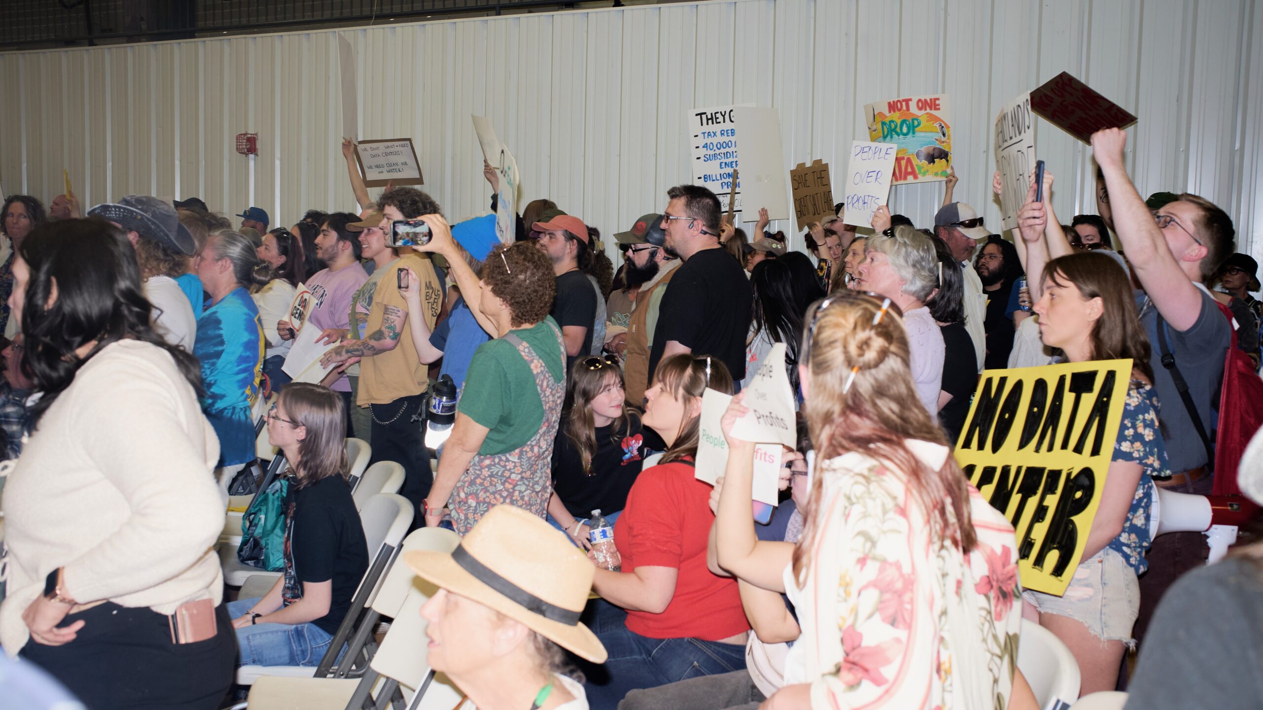 People raise signs against data center