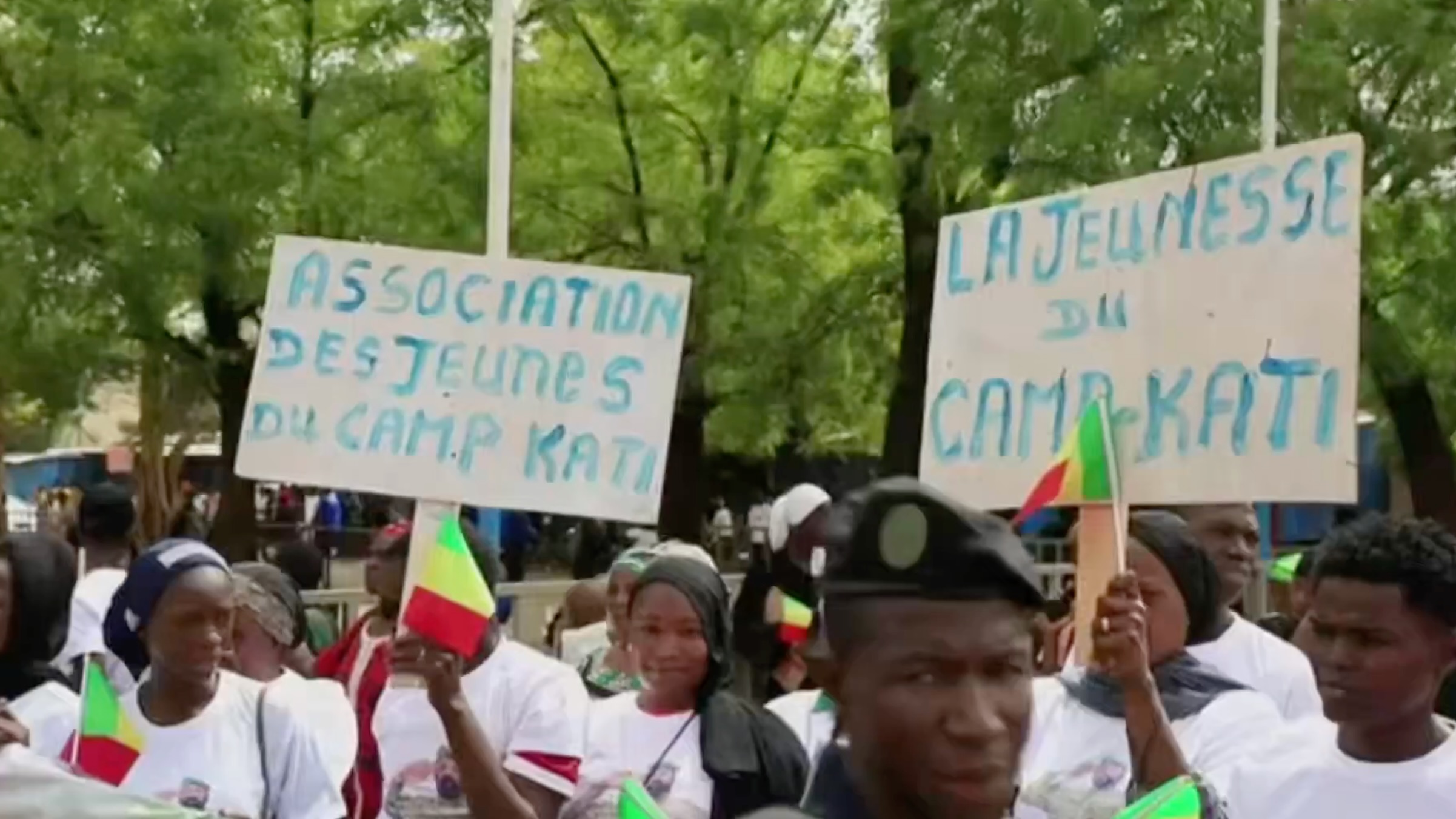 Malian people hold pro-government signs
