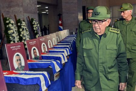 Raul Castro (3) Raúl Castro walks in front of coffins with Cuban flags over them